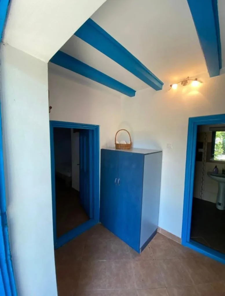Bright hallway with blue wardrobe and decorative basket