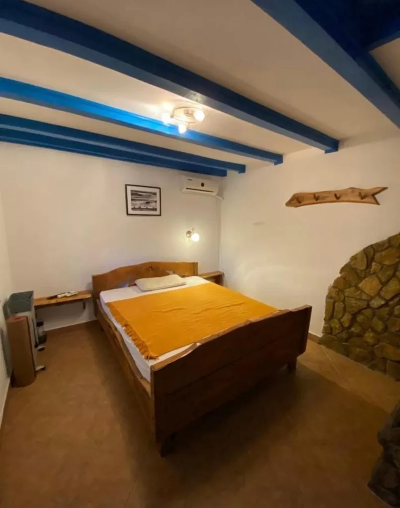 Rustic bedroom with blue beams and double bed